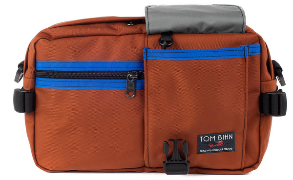 The LGD in Burnt Orange/Royal/Cloud. Front view, front buckle pocket lifted up to show the Cloud lining.